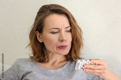 Young woman with pills, clo...