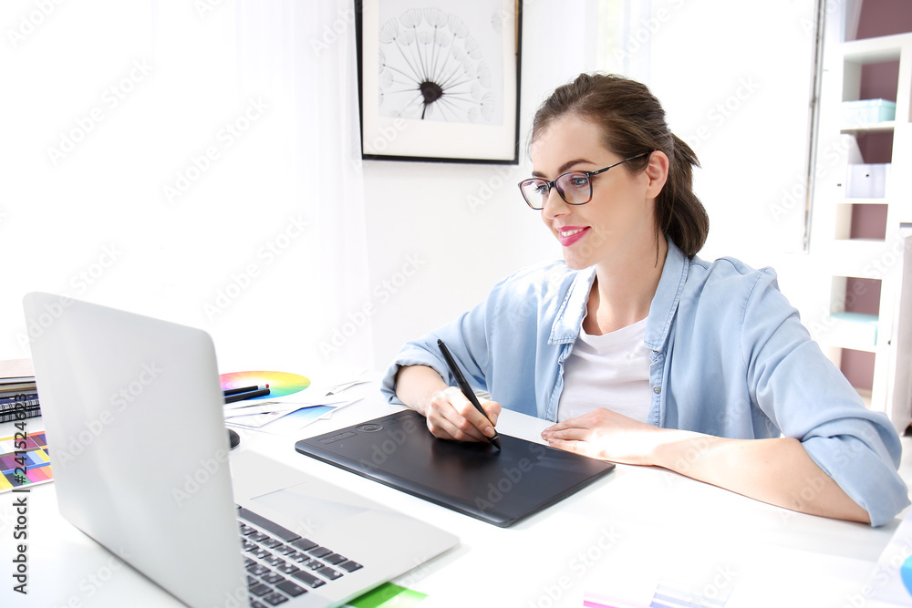 Beautiful young designer working in office Beautiful young designer working in office
