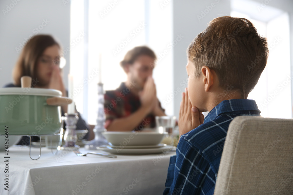 Family praying before meal at home Family praying before meal at home