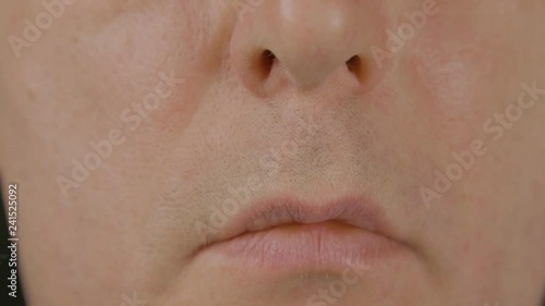 Close up male mouth, lips and nose. Clean shaven male face. Macro shooting people face. Male serious face, mouth, nose. Part of human face. Expression facial emotions
