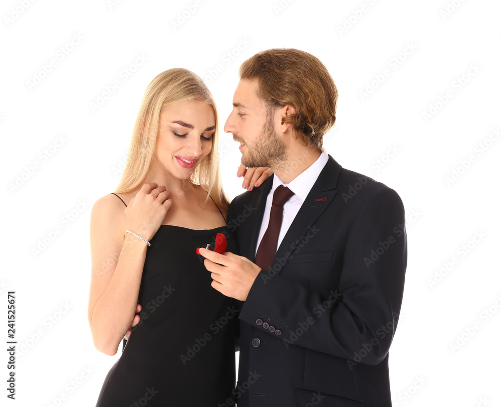 Young man proposing to his beloved on white background
