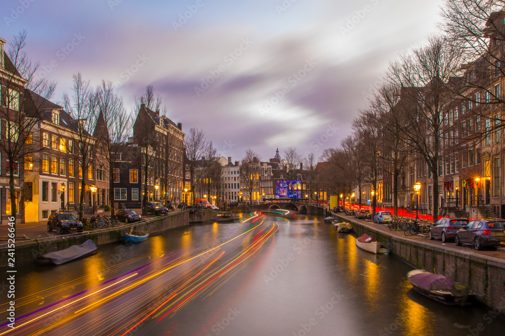 Fototapeta premium View on romantic canal Keizergracht in Amsterdam at night with city light and reflection on water