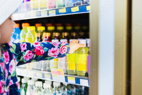 Sweet Asian girl shopping in mini mart with basket, enjoy buying thing in mart