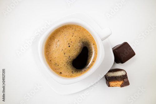 Cup of coffee espresso. Coffee cup and chocolate dessert on white background close up. Morning  breakfast  energy concept. Top view