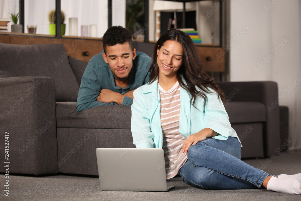 Young couple with laptop at home