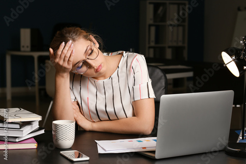 Tired businesswoman working...