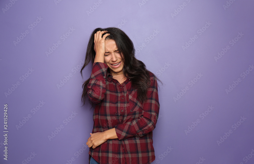 Stressed young woman on color background Stressed young woman on color background