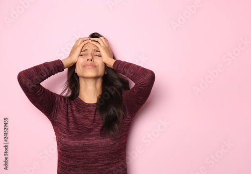 Stressed young woman on color background photo