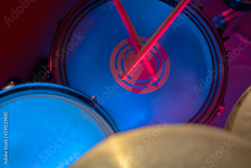 The drums and cymbal in an unusual colored light