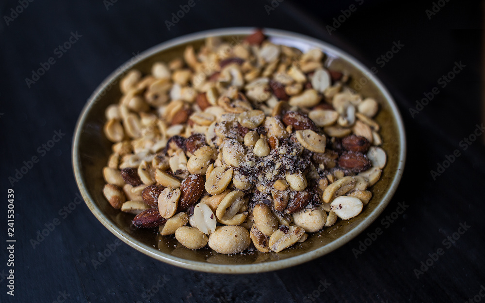 Peanuts nuts in a bowl on a dark background. Peanuts nuts in a bowl on a dark background.