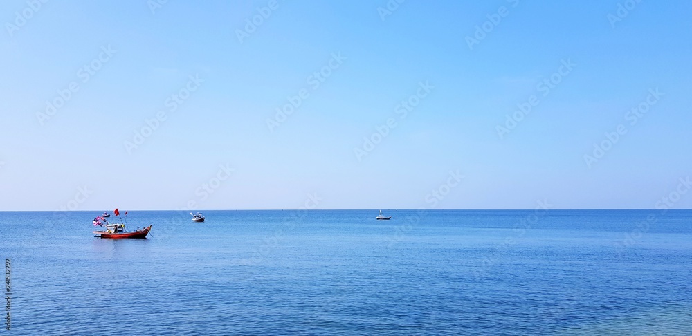 Fishing boat floating on the sea with clear blue sky and copy space - Beauty of Landscape, Ocean and Fishery concept Fishing boat floating on the sea with clear blue sky and copy space - Beauty of Landscape, Ocean and Fishery concept