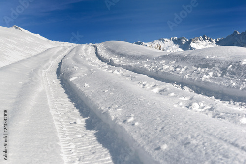 tracks on a road covering with fresh snow in hight mountain © coco