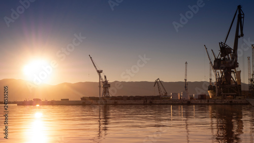 Beautiful and Colorful Sunset at the harbor of Rijeka with urban industry and cargo flair in Croatia