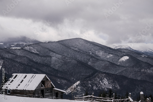 House on the mountain valley in winter photo