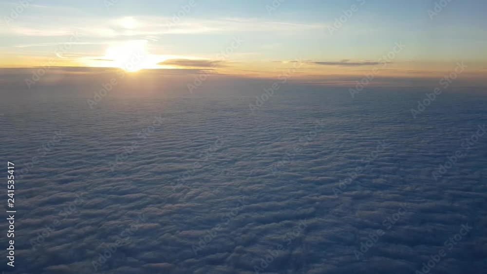 Aerial shot of violet clouds from aircraft window at arty sunset in summer Aerial shot of violet clouds from aircraft window at arty sunset in summer