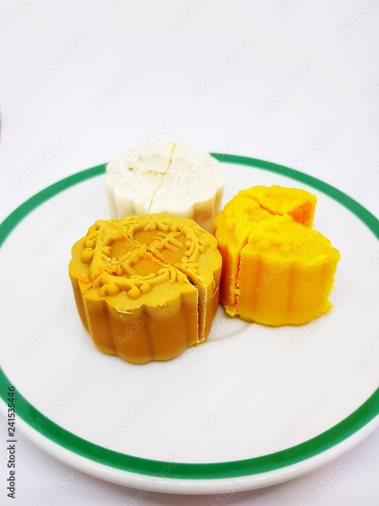 Close up sweet moon cake in plate isolated on white background with copy space - Food and dessert concept Close up sweet moon cake in plate isolated on white background with copy space - Food and dessert concept