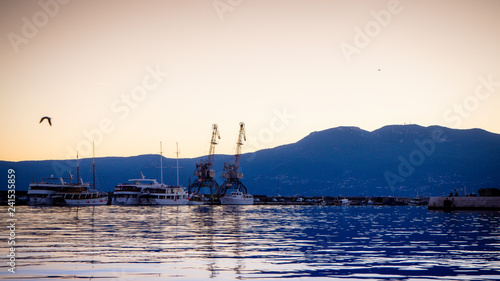 Beautiful and Colorful Sunset at the harbor of Rijeka with urban industry and cargo flair in Croatia photo
