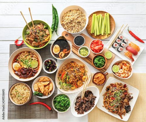 Obraz na plátně Assortment of Chinese food on white wooden table