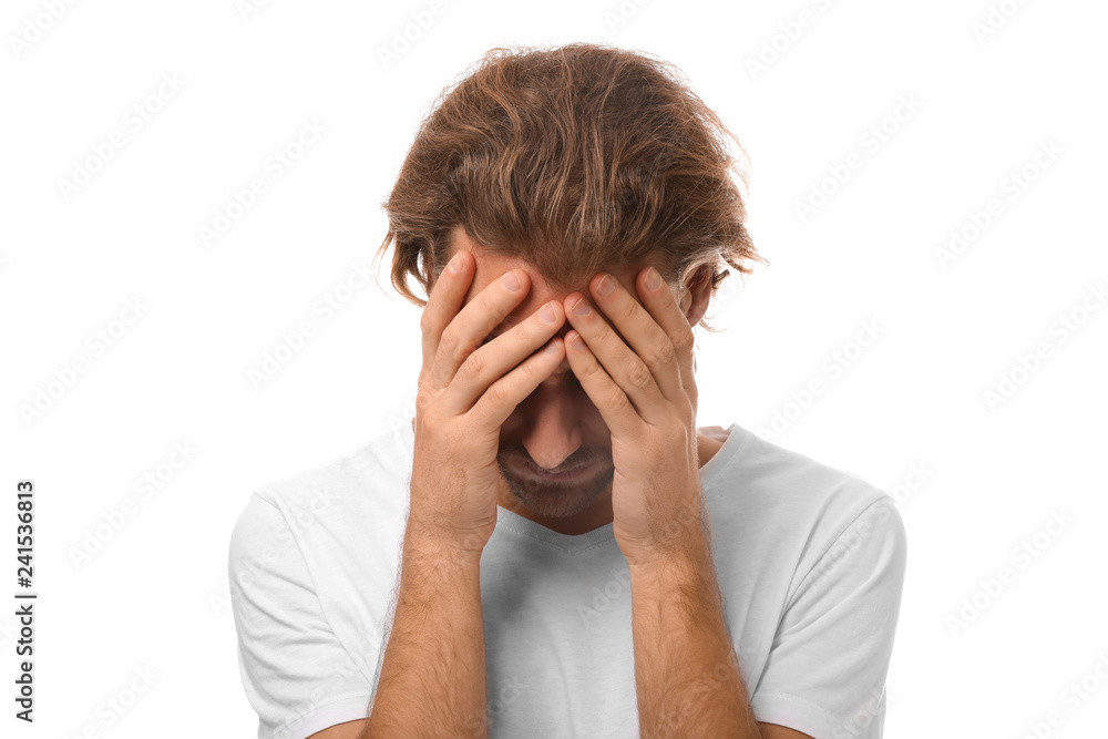 Young man suffering from headache on white background Young man suffering from headache on white background