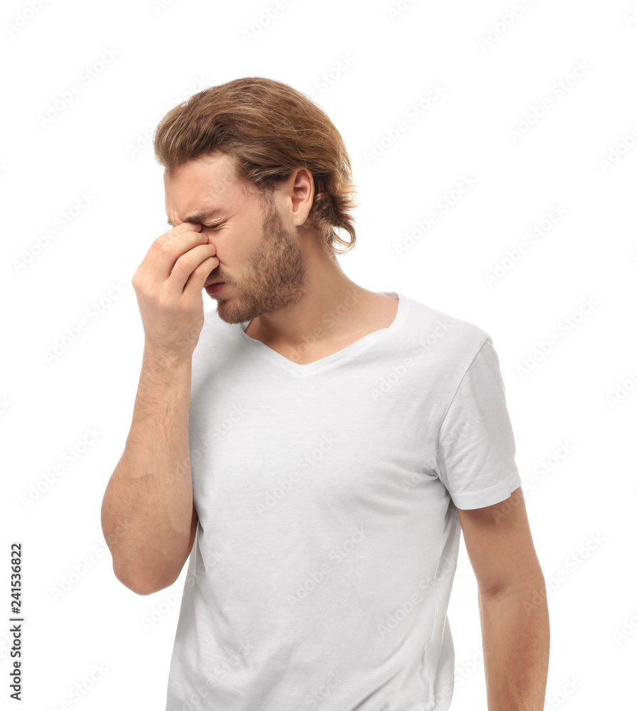 Young man suffering from headache on white background Young man suffering from headache on white background