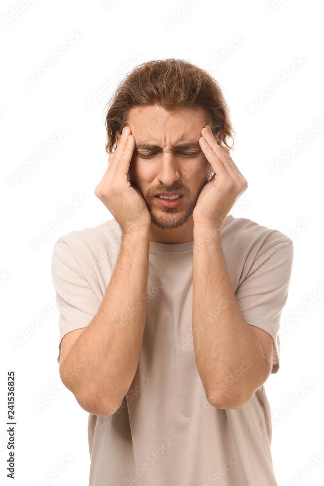 Young man suffering from headache on white background Young man suffering from headache on white background