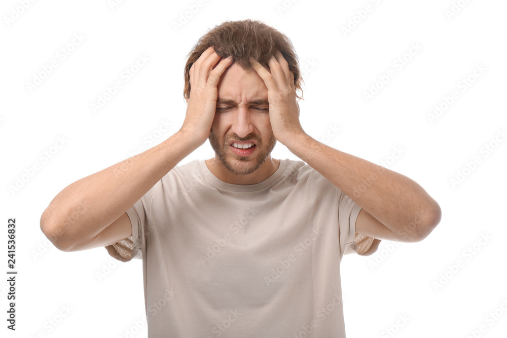 Young man suffering from headache on white background Young man suffering from headache on white background