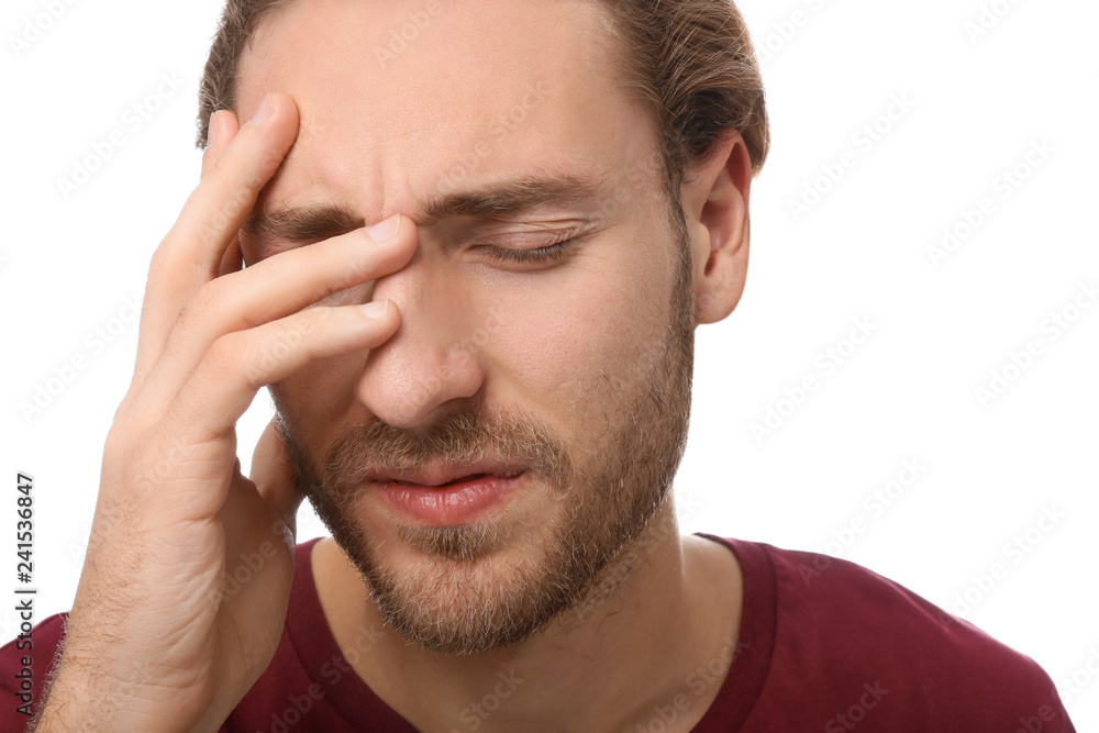 Young man suffering from headache on white background, closeup Young man suffering from headache on white background, closeup