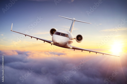 Luxury private jetliner flying above clouds.