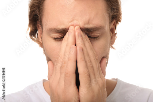 Wallpaper Mural Young man suffering from headache on white background, closeup Torontodigital.ca
