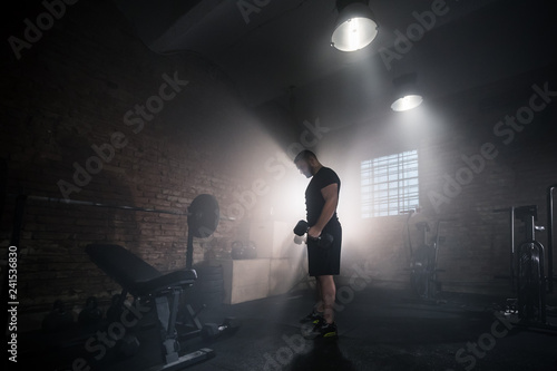 Weightlifter flipping one-handed dumbbell