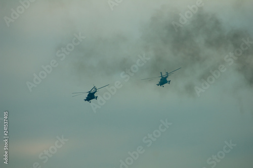 Fototapeta Naklejka Na Ścianę i Meble -  Military helicopter fired anti-armor missiles at sunset