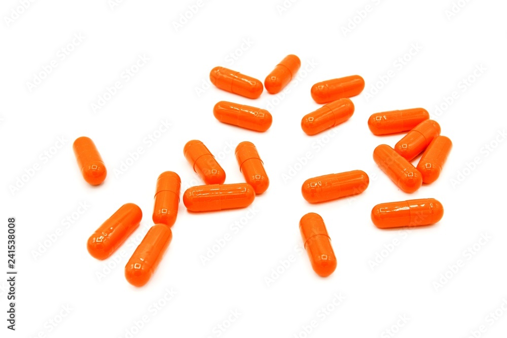 Orange or Yellow capsule pill isolated on white background - Medical or Medicine and Herb concept Orange or Yellow capsule pill isolated on white background - Medical or Medicine and Herb concept