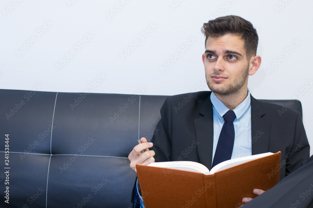 portrait of business man with book or agenda portrait of business man with book or agenda