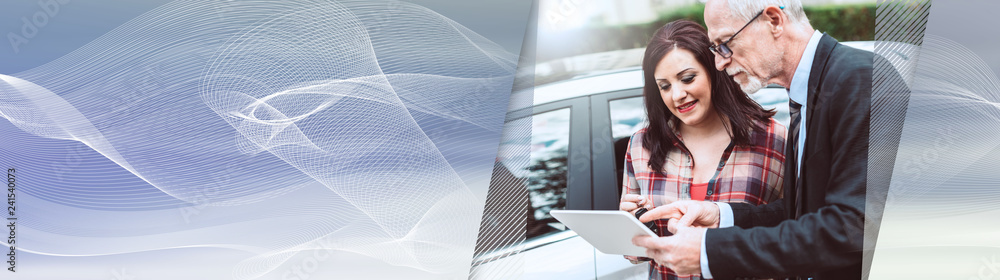 Car salesman giving explanations on tablet to young woman, light effect. panoramic banner Car salesman giving explanations on tablet to young woman, light effect. panoramic banner