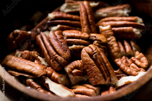 Peeled Pecan Nuts in Wooden Bowl without Shell / Walnuts close up macro view.
