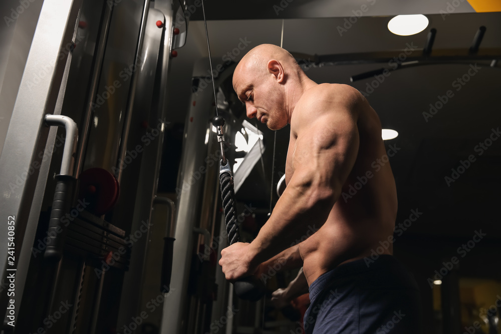 Muscular man training in gym Muscular man training in gym