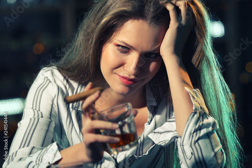 Young woman drinking alcoho...