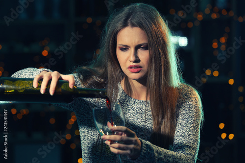 Young woman drinking alcoho...