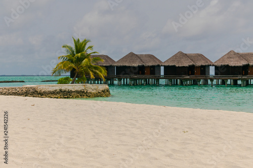 Amazing island in the Maldives ,water villa ,white sandy beach  and beautiful  turquoise waters with  blue sky  background for holiday vacation . © Umarin