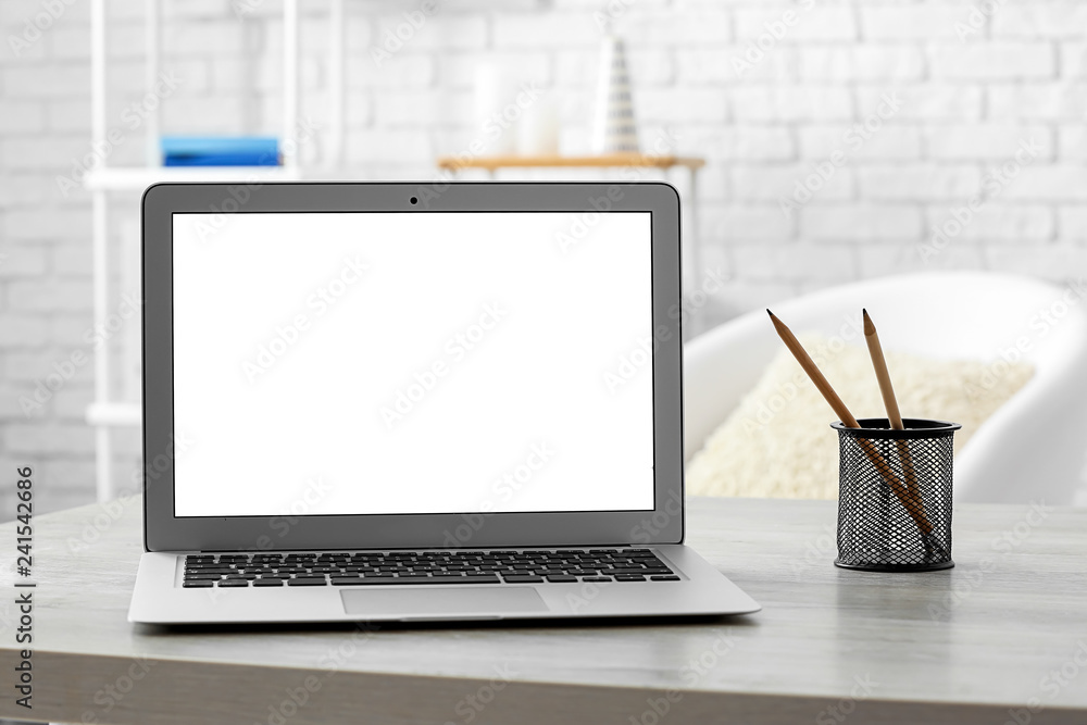 Fototapeta premium Modern laptop on table in room