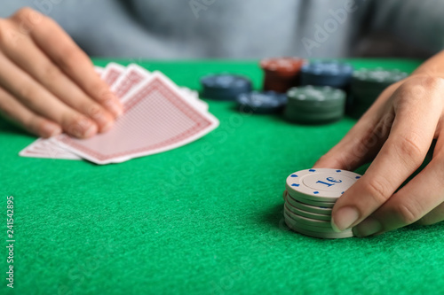 Young woman playing poker in casino, closeup