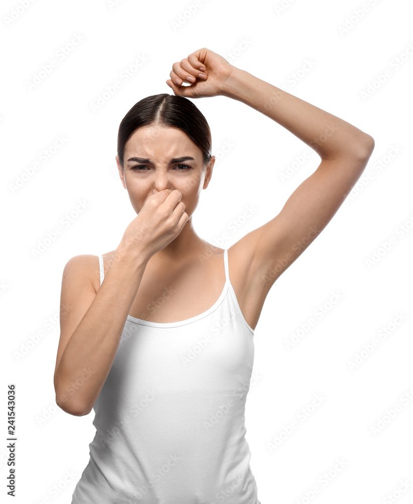 Beautiful young woman feeling smell of sweat on white background. Concept of using deodorant Beautiful young woman feeling smell of sweat on white background. Concept of using deodorant