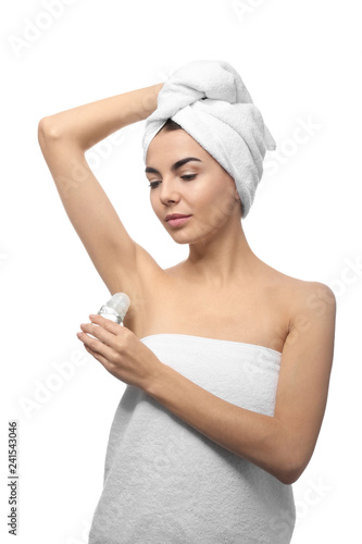 Young woman using deodorant...