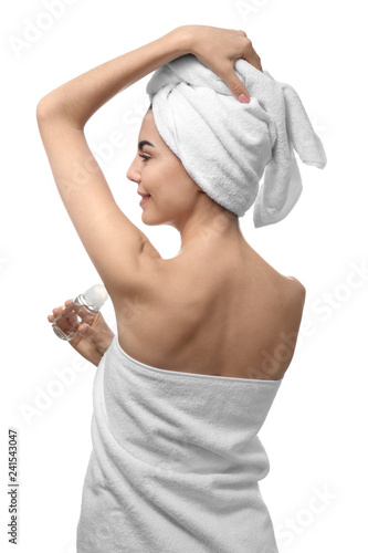 Young woman using deodorant...