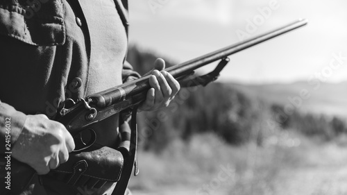 Hunter with horizontal double-barreled shotgun on hunting