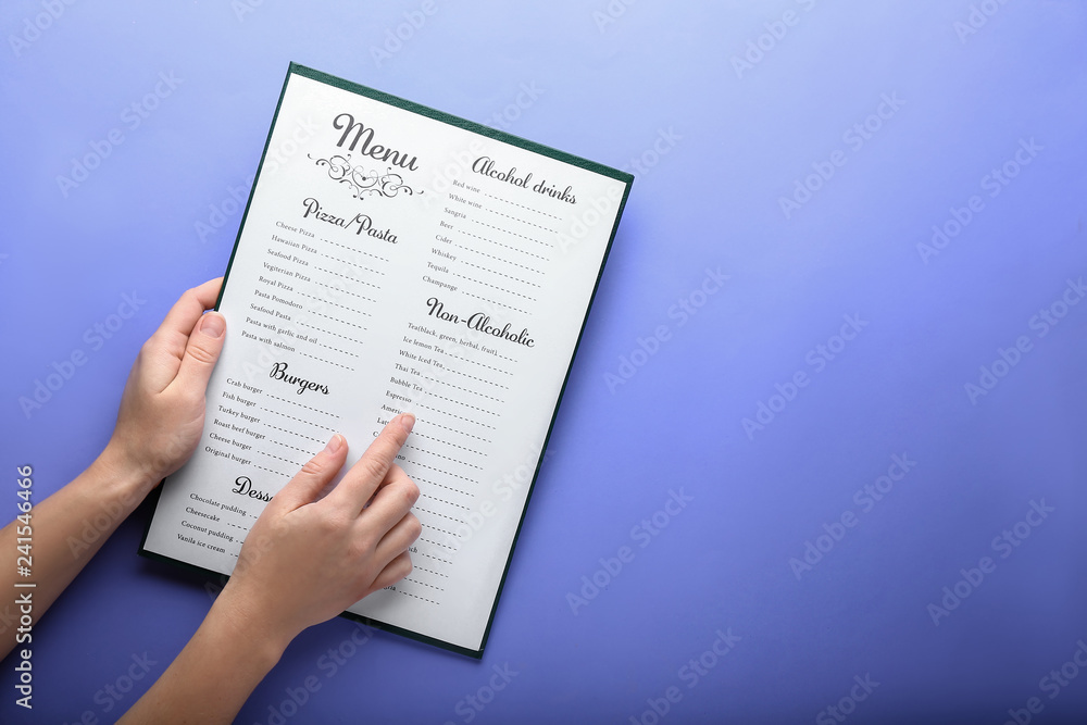 Female hands with menu on color background - obrazy, fototapety, plakaty 