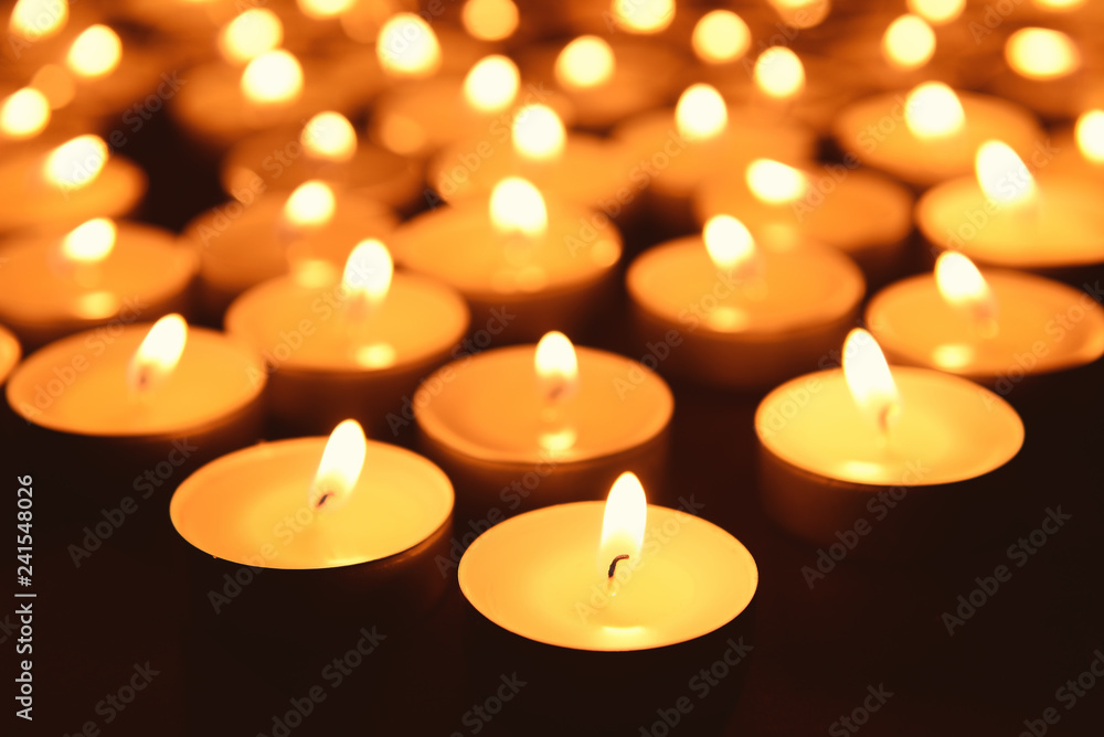 Beautiful burning candles on dark background, closeup Beautiful burning candles on dark background, closeup