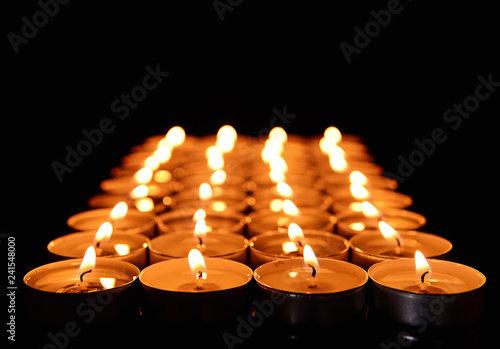 Rows of Burning Tea Light C...