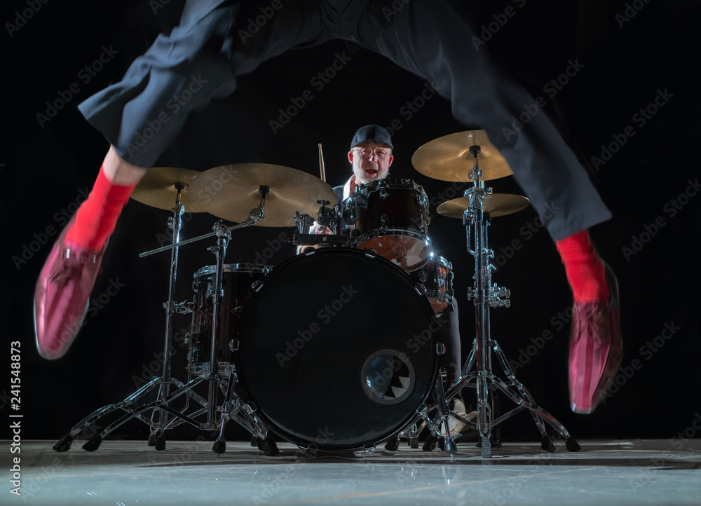 Fototapeta premium Feet dancer on the background of the drummer