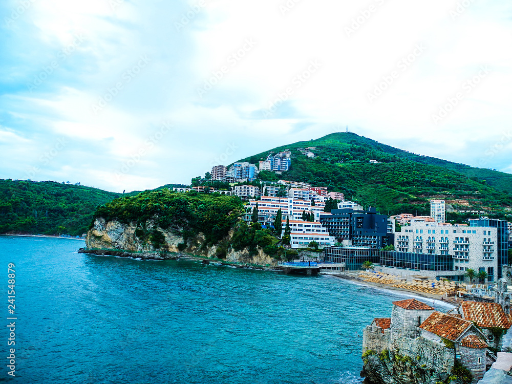 Budva, Montenegro. Turquoise waters of Adriatic sea and orange tile roofs.